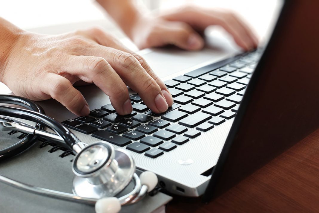 Doctor working with laptop computer