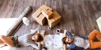 The Moving Day Details That Get Overlooked Until Everything Goes Wrong Young couple moving in new house, drinking coffee.