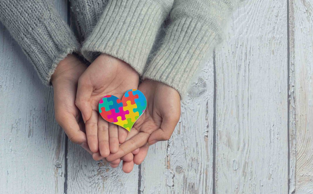 Closeup on two young lovers holding hands at a table. Autism Spectrum Disorder