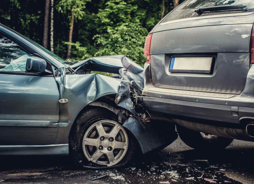 Close up smached cars on a road. Important Actions to Take After a Car Accident